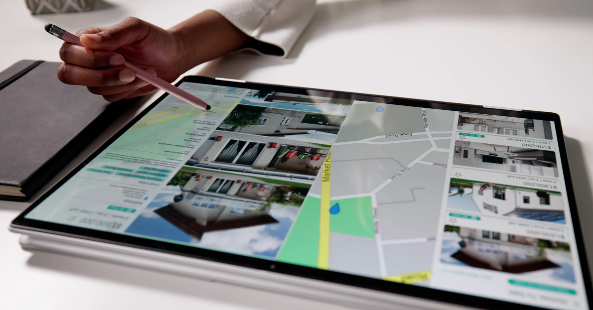 Person searching for real estate on iPad to relate to the article's topic: August 2025 Housing Market Update.