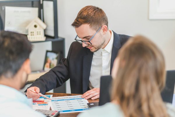 Loan officer reviewing documents with clients