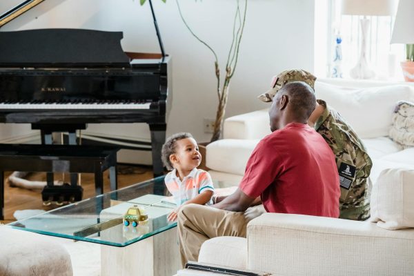 Service member with family at home